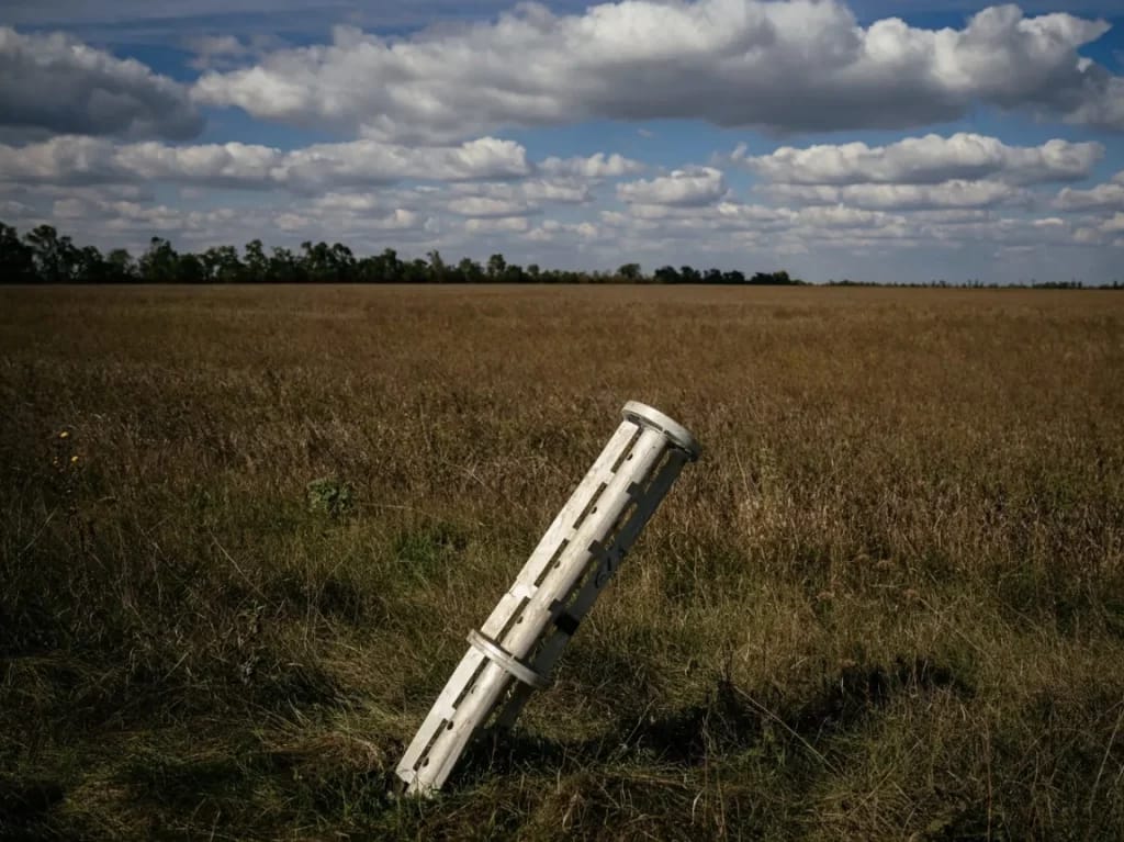 This photograph taken on October 7, 2022 shows a Russian rocket sticks out a ground near the village of Ukrainka in a part of Southern Ukraine.